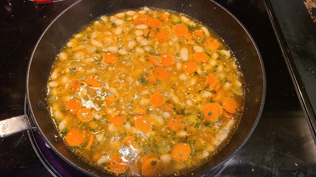 Add chicken broth and oregano to skillet, stir, then add the drained beans. Season with salt and pepper to taste at this point.
