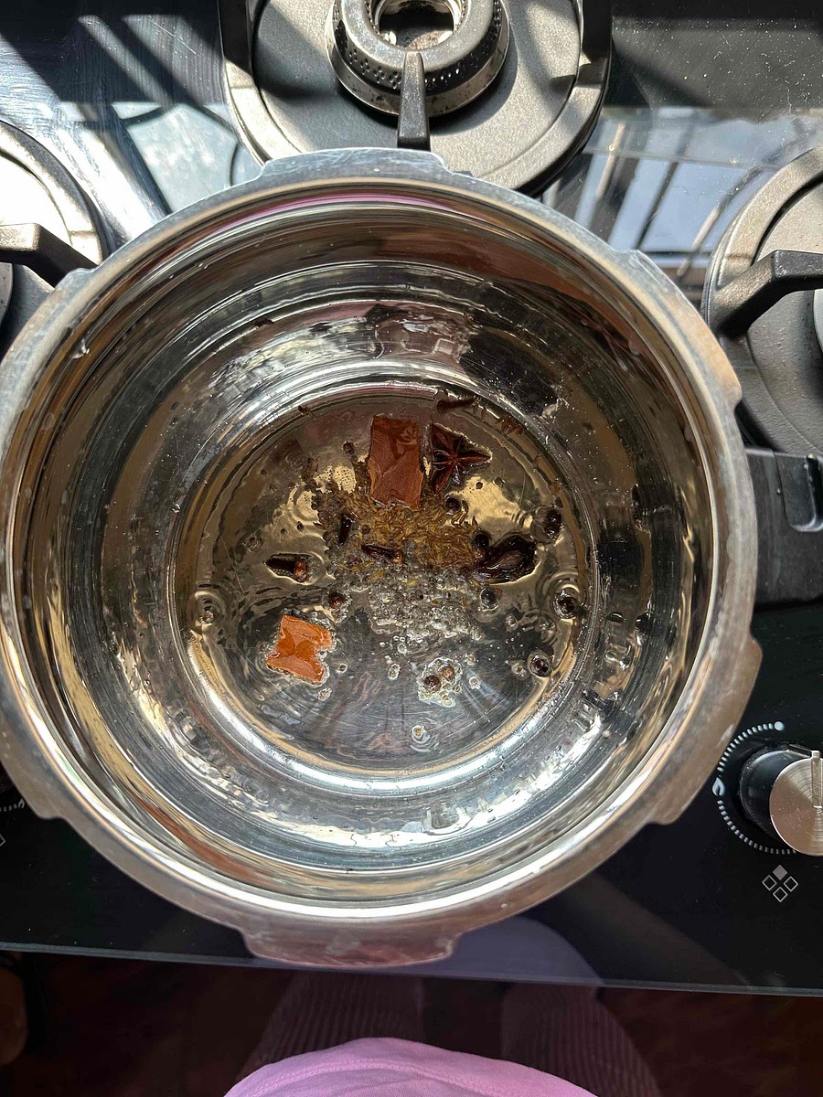 In a pot, heat oil, add jeera, rai, and whole spices.