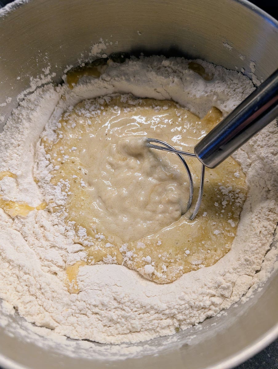 Sieve the flour into a large bowl, mix in the sea salt and make a well. Add in the middle the olive oil and the white wine, and slowly stir the liquid in the well with a spatula or dough whisk letting it to slowly incorporate the flour.
