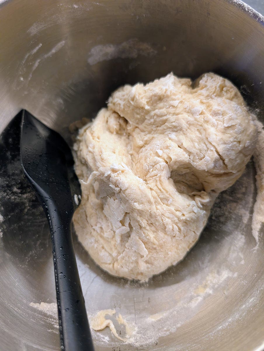 Keep mixing and folding the ingredients with the spatula until you have a rough dough. There still will be some loose flour.
