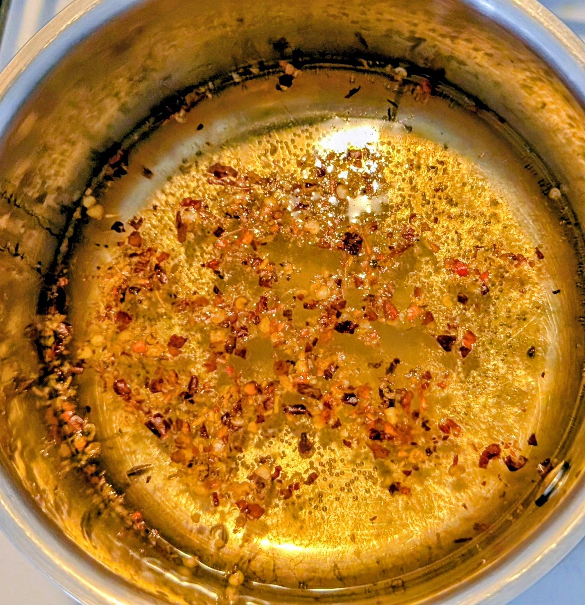 Add all other ingredients to a small sauce pan and bing it to a gentle simmer at medium heat. Simmer it for 1-2 minutes. Crushed chillies are optional, for a bit of heat.