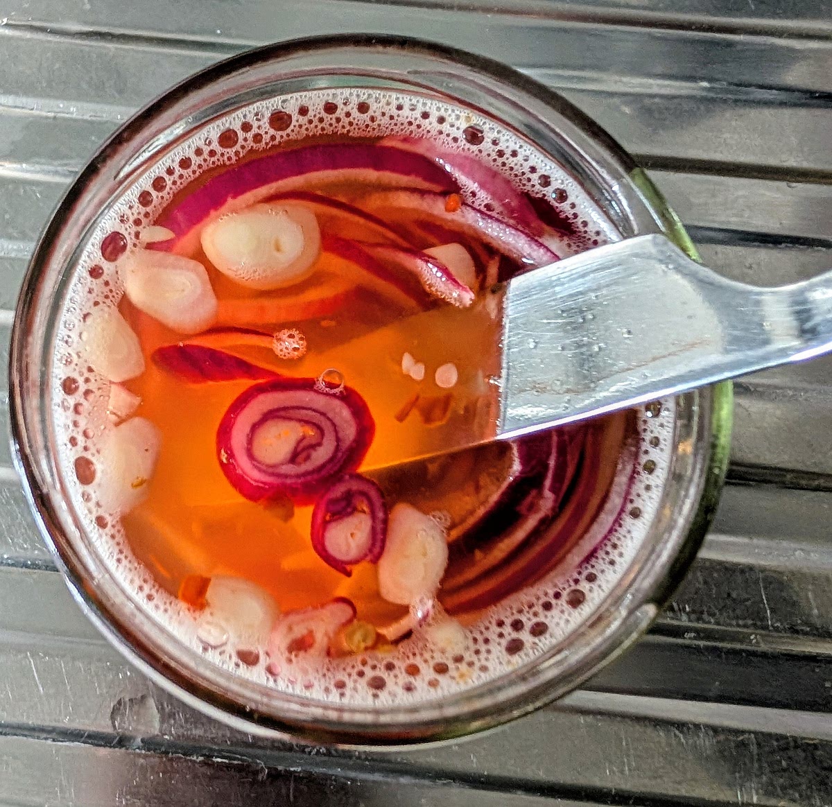Push the onions down into the liquid with a butter knife, making sure that onions are covered and any remaining air bubbles come to the surface.