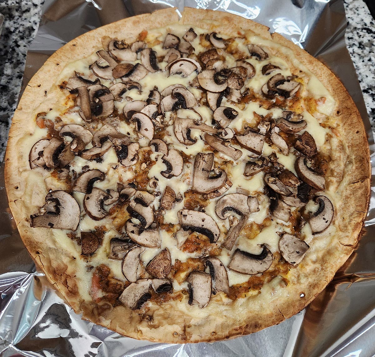For use on pizza, drizzle the simmered sauce over personal pan pizza crusts or crusts already layered with marinara. I topped my 4 thin personal sized pizza crusts with carrot marinara, this cheese sauce, and 2 cartons (16oz) of thinly sliced mushrooms. Bake your pizza at 400F / 204c for 10 min, then check on it and cook longer if needed until your cheese sauce and toppings are lightly browned. My pizza took about 15 min. to bake. With heat from the oven, the cheese sauce thickens and goops up into a deliciously cheesy mozzarella. It makes 4 servings, or 4 personal pan pizzas' worth of vegan mozzarella.