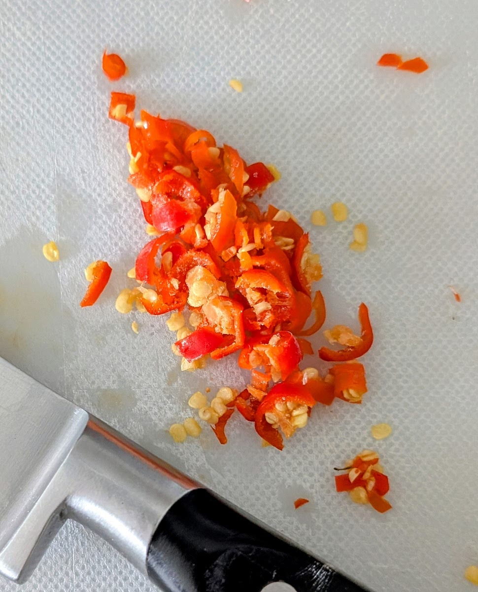 Chop the chillies. You can remove or leave the seeds, depending on how much spicy you want the dish. I’ve left them in.