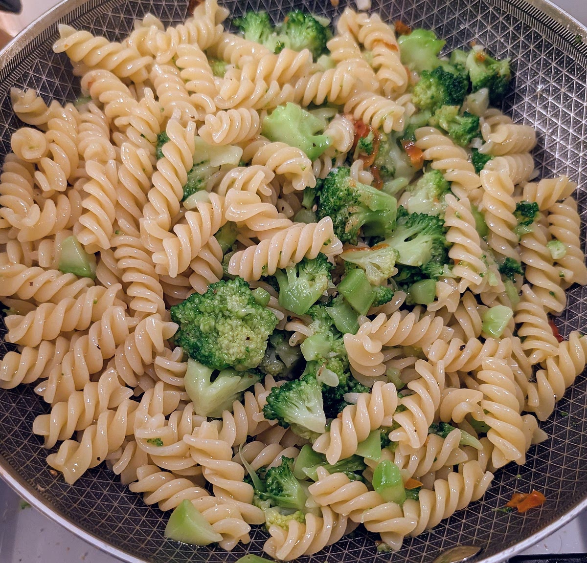 Put the pan on high heat, add the remaining 2tbsp of Olive oil, add freshly ground pepper to taste and toss it all together. Taste, adjust seasoning if needed.