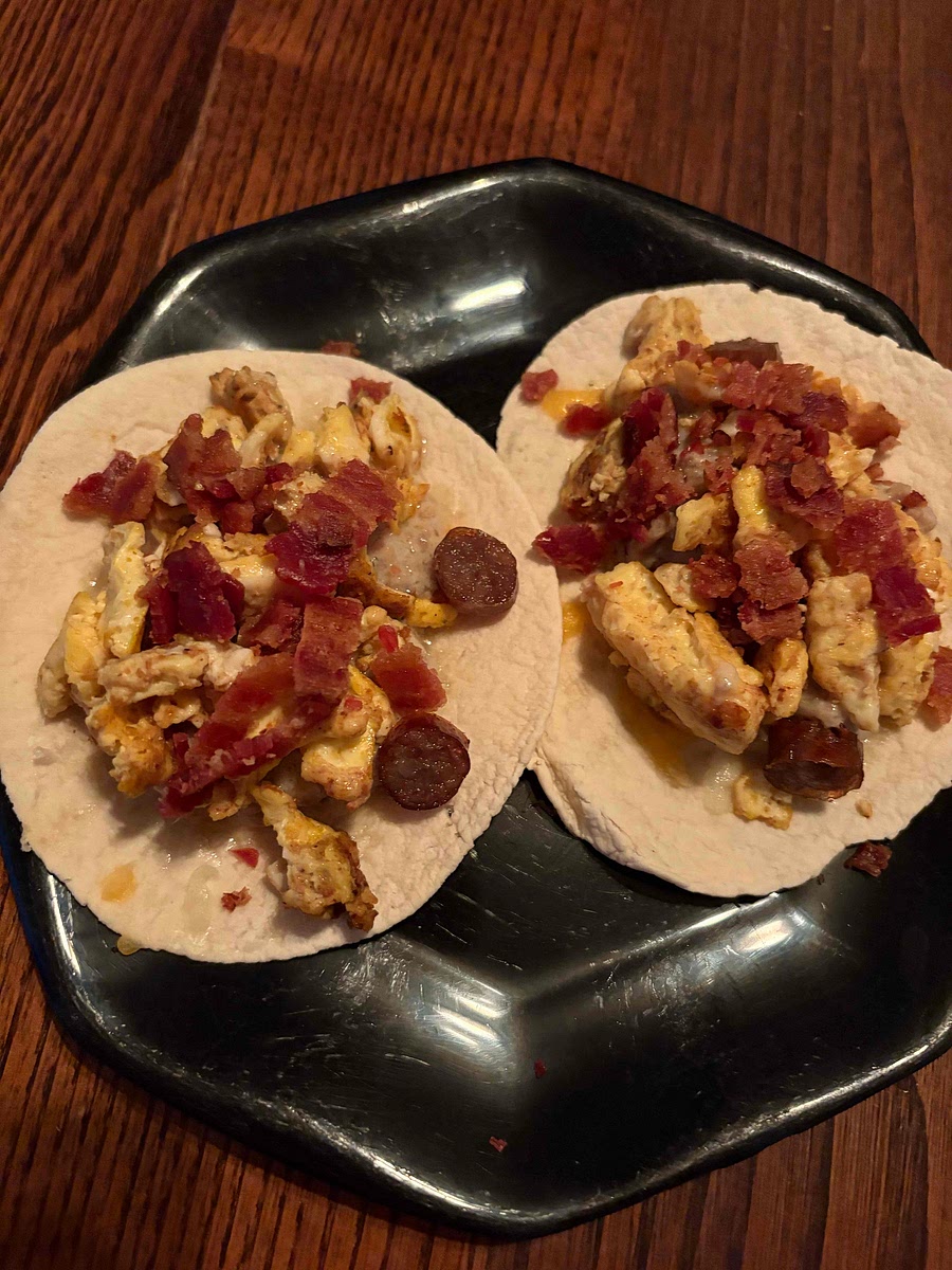 Assemble tacos, put some of the sausage and gravy, then eggs, then meat and other toppings.