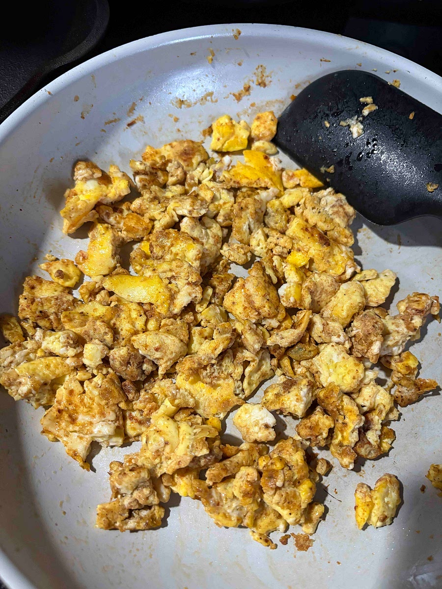Scramble the eggs with taco seasoning when fully cooked take off heat and add taco sauce as desired
