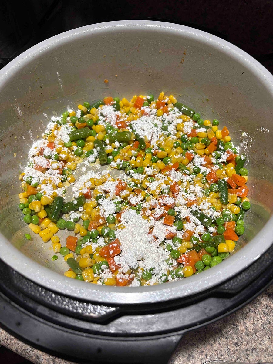 Add a layer of flour to cover the vegetables and cook flour off for about three minutes.