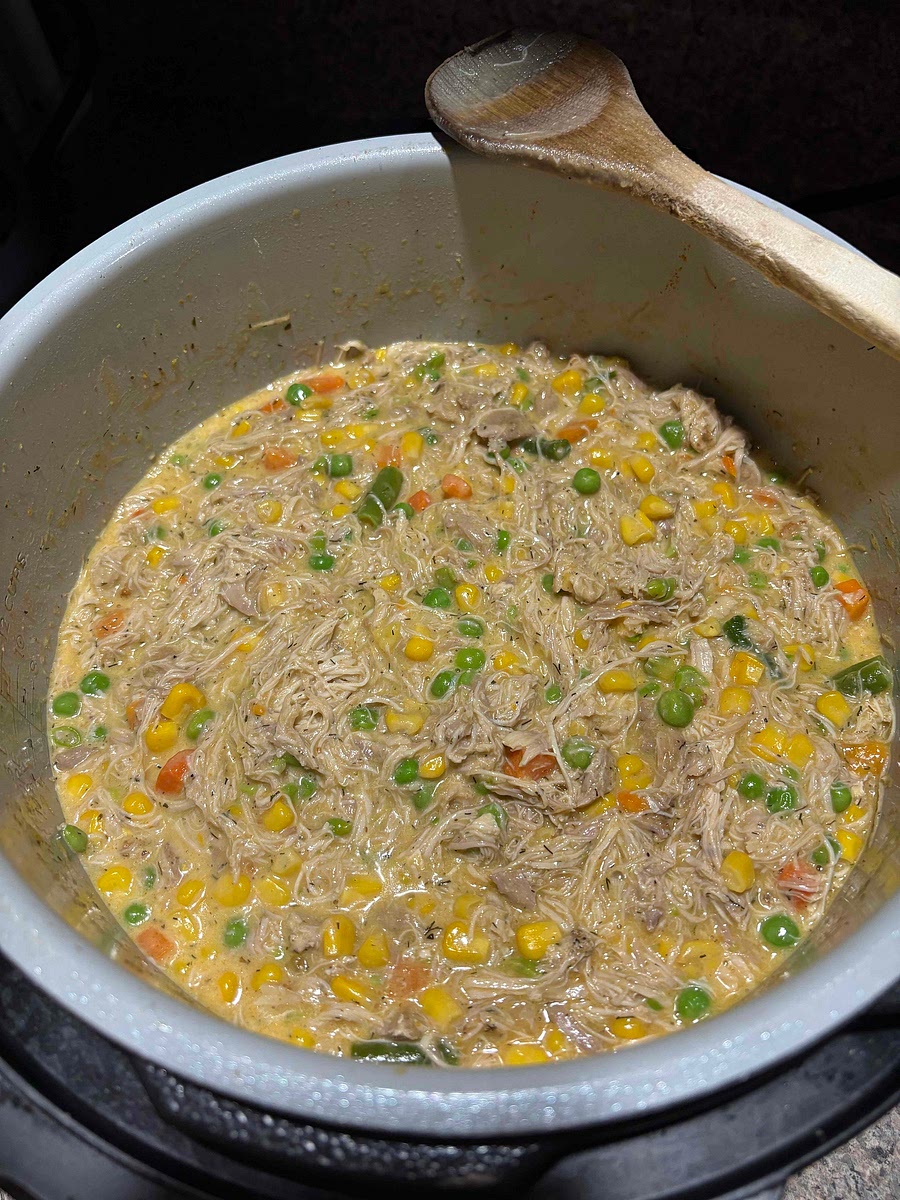 Add shredded chicken to the vegetables if you are making chicken pot take the mixture put it into a dish and bake at 375 for 15 minutes if making chicken pot pie continue.