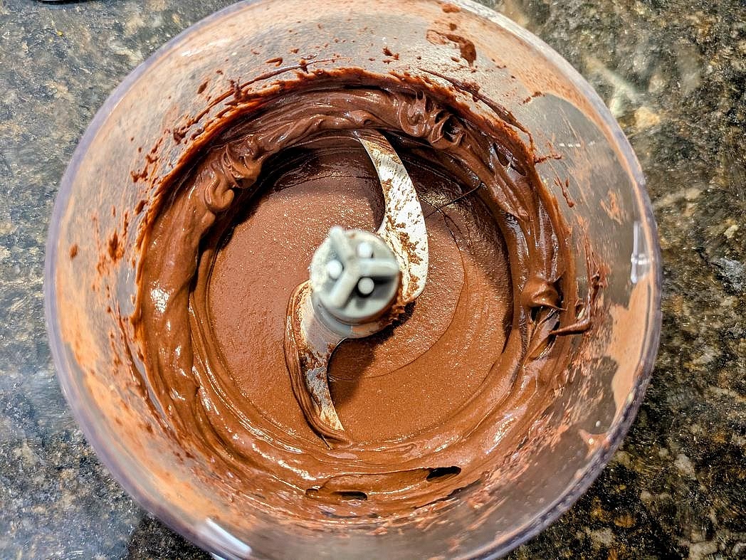 In a small food processor, blend together avocado, protein powder, cocoa powder, vanilla extract, and salt. Sweeten to taste, transfer to a small bowl, and enjoy