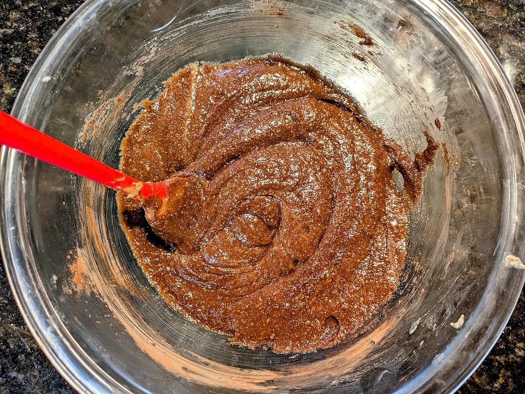 Add in the dry ingredients (baking powder, cocoa powder, and almond flour), and mix with a silicone spatula until fully combined