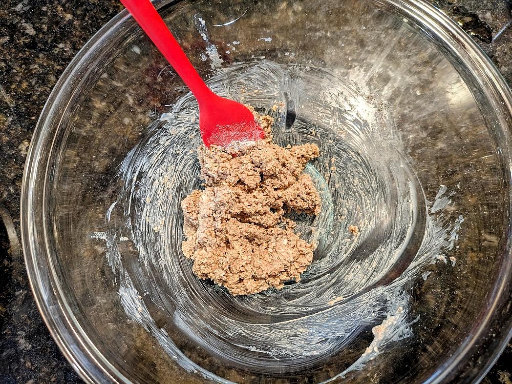 In a large glass bowl, combine together the crust ingredients - oat flour, melted coconut oil, vanilla extract, liquid monk fruit, cinnamon, and salt
