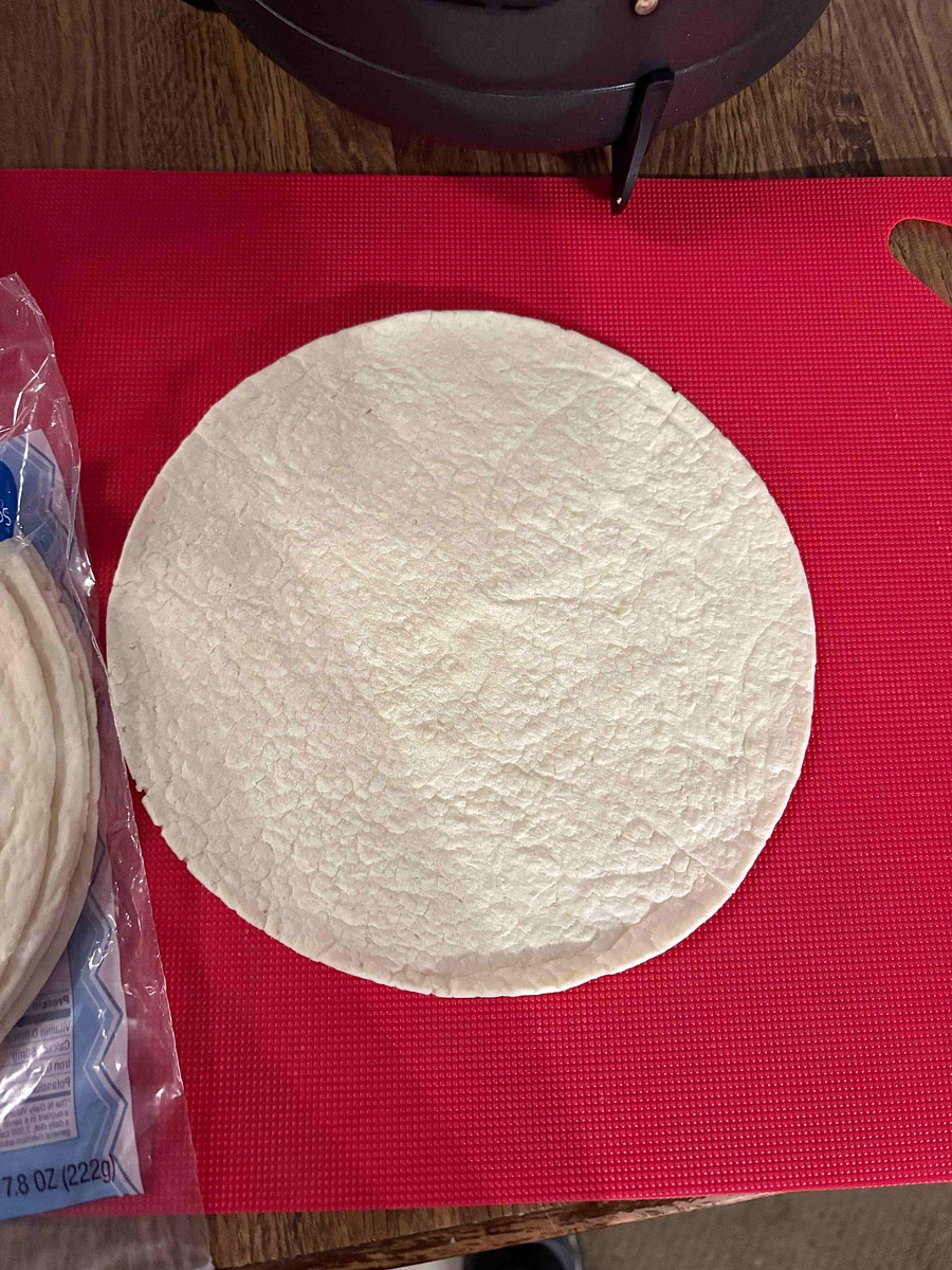 On a low carb tortillas spread tomato sauce you can add Italian spices, salt, and pepper if your sauce is plain.