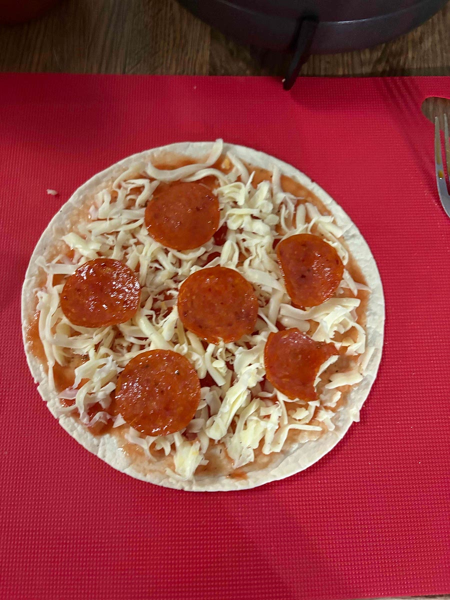 Add mozzarella cheese and your toppings make sure to leave a little space at the edge of the pizza so it doesn’t overflow.