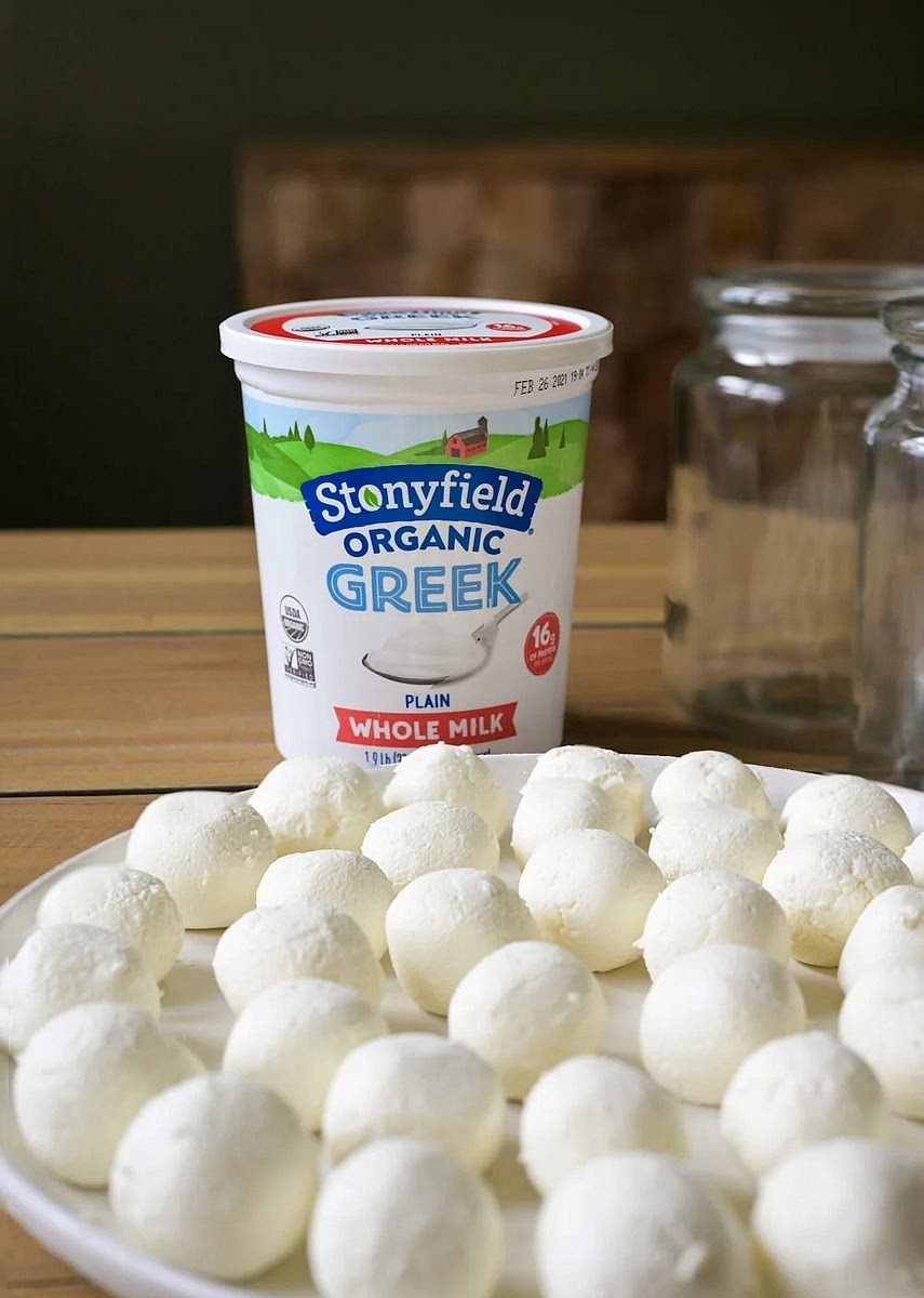 With well-oiled hands, take labneh balls and roll into small balls