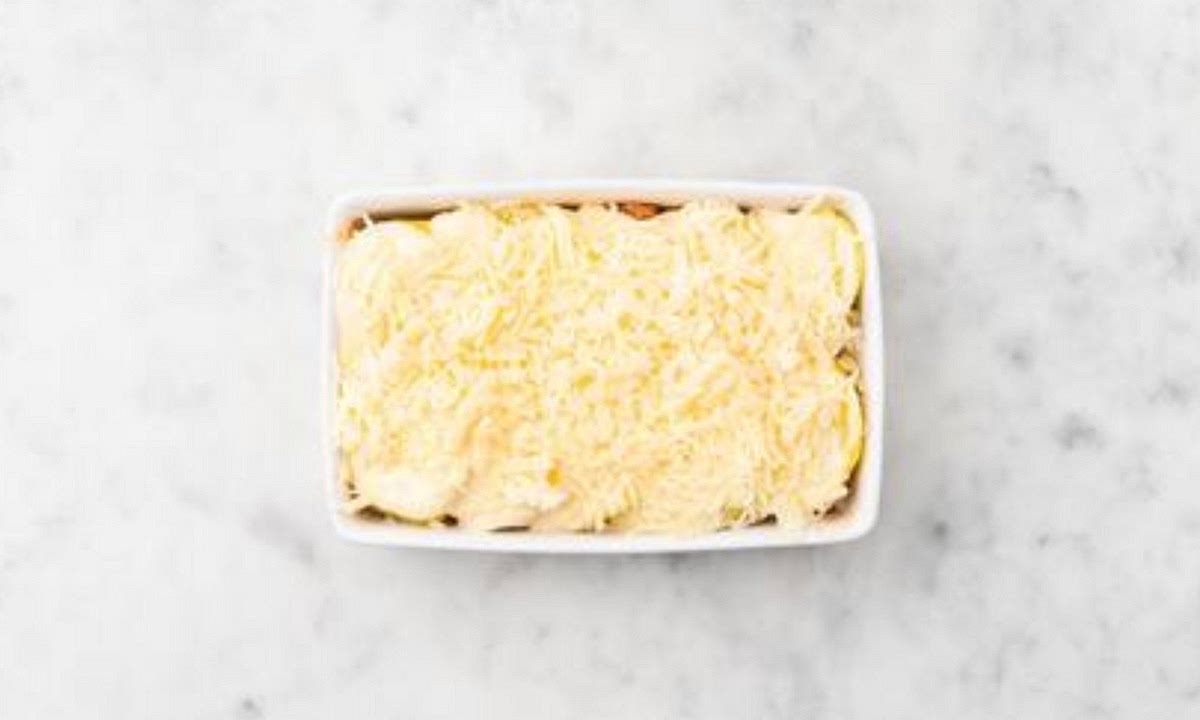 Once the beef mixture is ready, spoon into an
appropriately sized ovenproof dish. Carefully lay the cooked potato slices in layers over the top, then pour over the creamy sauce. Sprinkle over the hard Italian style cheese. Bake on the top shelf of your oven until golden brown and bubbly, 15 -20 mins. TIP: Put the dish onto a baking
tray to catch any drips.