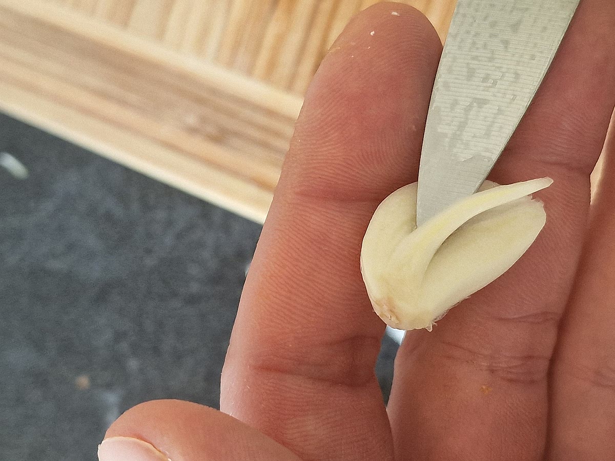 Still prep phase: if you're adding garlic (which is also optional) I recommend to cut it in half and remove the middle part. This is usually better to do if you are using either raw garlic or are cooking it just slightly but to me this is just common practice and I just always do it.