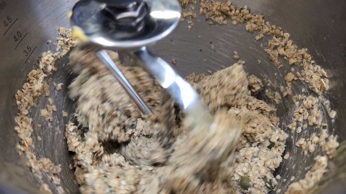 Put the butter, sugar and golden syrup into a large saucepan and melt over a low heat, stirring until the mixture is melted and combined. Remove from the heat. Top, tail and wash the gooseberries and add to the melted mixture, together with the oats, salt and the toasted seeds and hazelnuts, mixing well to combine. Spoon the mixture into the prepared baking tin, pressing level with the back of a spoon.