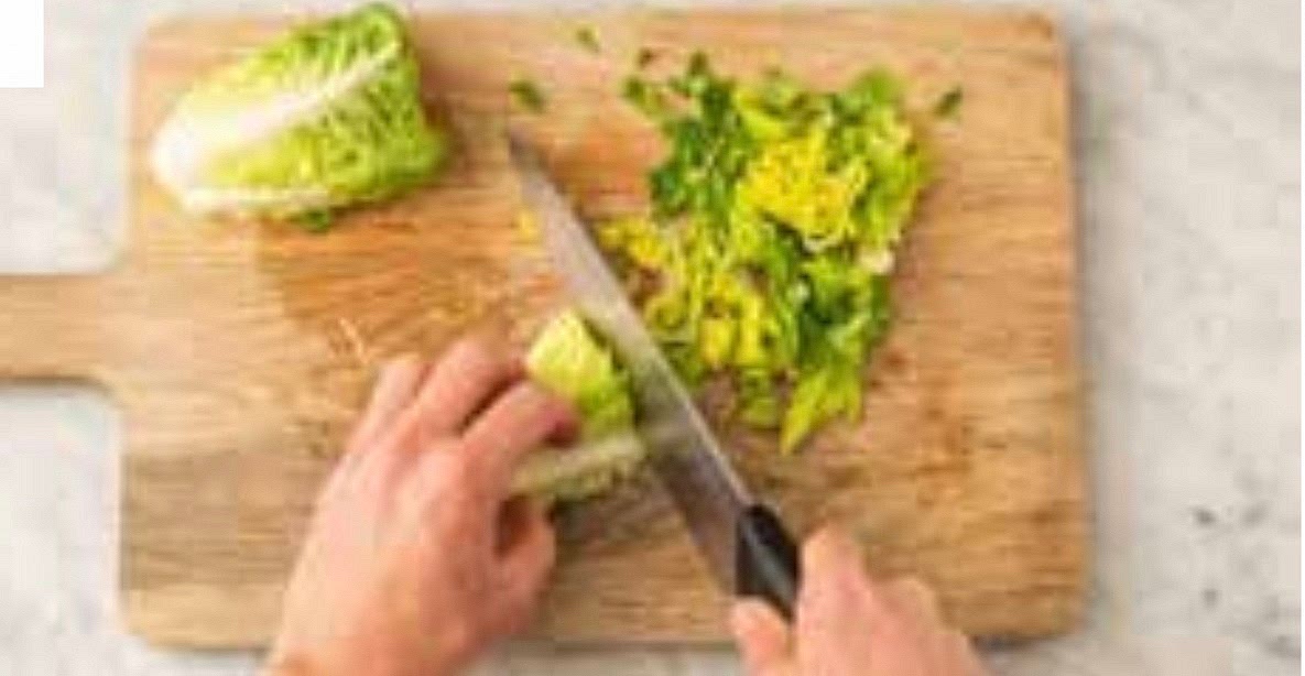 Meanwhile, zest and halve the lime. Trim the baby gem and reserve 1 leaf per person. Halve the remaining lettuce lengthways, then thinly slice widthways. Sandwich each chicken breast between two pieces of baking paper or cling film. Pop onto board, then give it a bash with the bottom of a saucepan until it's 2-3 cm thick.