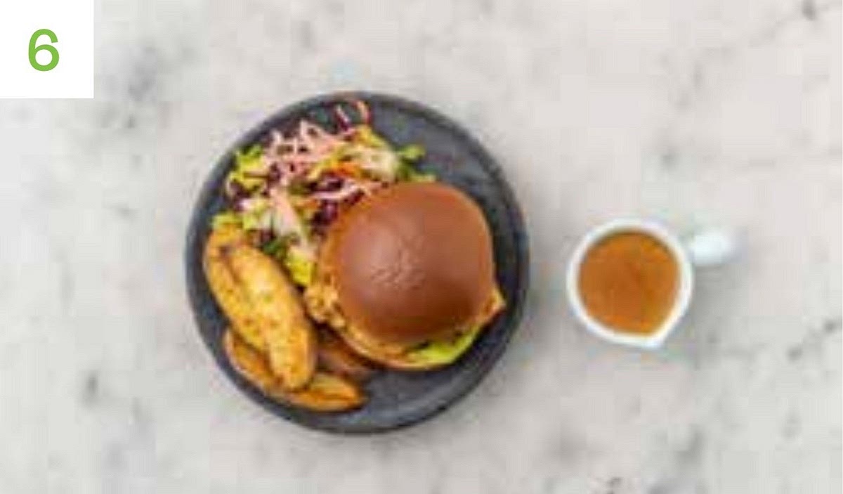 Reheat the satay sauce if needed and spread a spoonful on each side of your buns. Pop a lettuce leaf on the bun base, top with a chicken breast, then finish with the bun lid. Serve your burgers with the baby gem slaw and wedges alongside. Pop the remaining satay sauce in a small bowl for dipping.