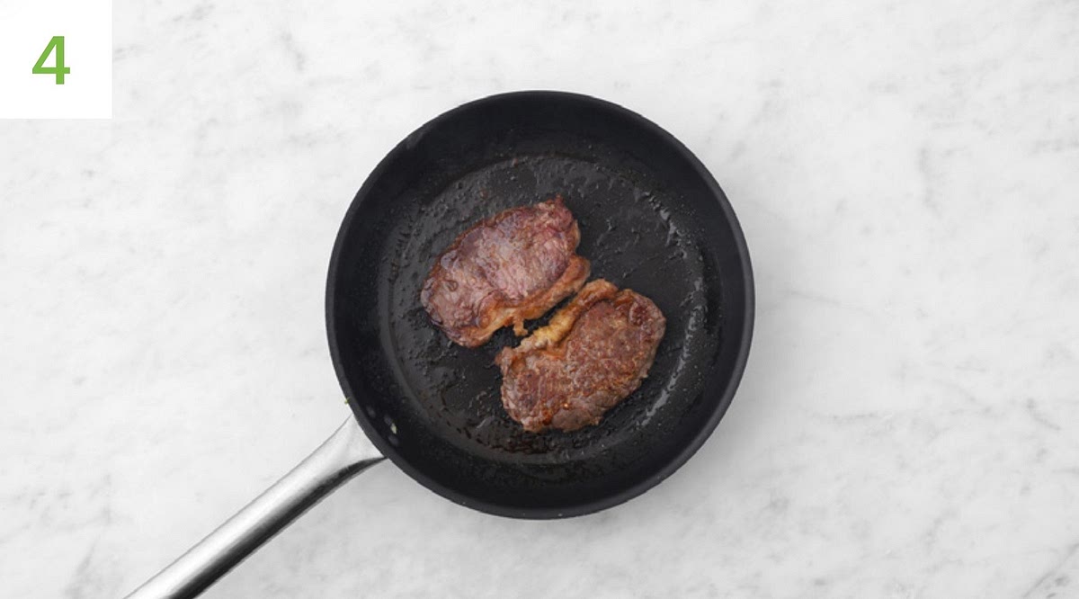 Wipe out the (now empty) frying pan, then return to a high heat with a drizzle of oil. Season the steaks with salt and pepper. TIP: Rump steaks naturally vary in shape, so adjust the following timings depending on how you like yours cooked. Once very hot, lay the steaks into the pan and fry until browned and medium-rare, about 5 mins. Turn halfway through. TIP:Cook each side for 1 min more if you like it more well done. Once the steaks are cooked, transfer to a board, cover with foil and allow to rest for a couple of mins.