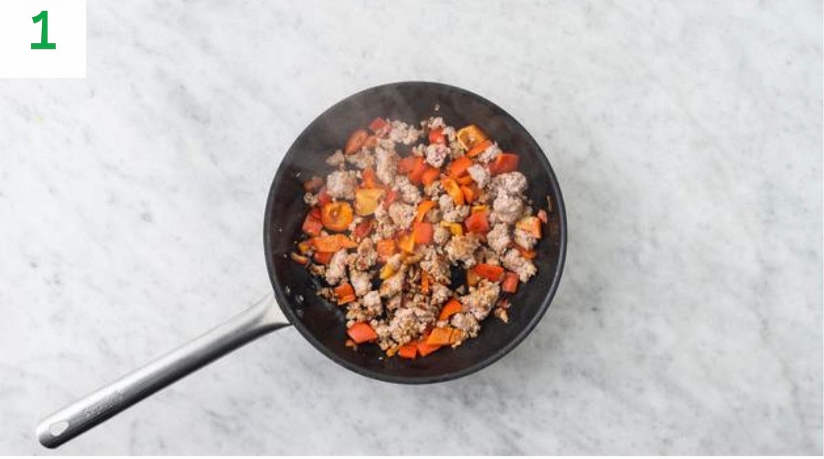 a) Preheat your oven to 240°C/220°C fan/gas mark 9. b) Halve the bell pepper and discard the core and seeds. Chop into roughly 1cm pieces. c) Heat a drizzle of oil in a large frying pan on medium-high heat. d) Once hot, add the pork mince and chopped pepper. Fry until browned, 5-6 mins. Use a spoon to break up the mince as it cooks.