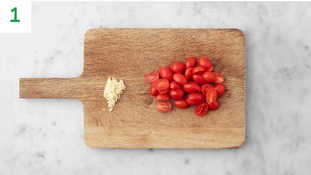 a) Preheat your oven to 220°C/200°C fan/gas mark 7. Bring a large saucepan of water to the boil with ½ tsp salt for the pasta. b) Halve the baby plum tomatoes. c) Peel and grate the garlic (or use a garlic press).