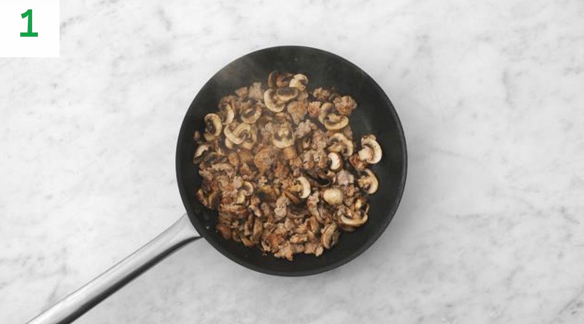 Boil a full kettle for the pasta.
Heat a drizzle of oil in a large frying pan on high heat.
Once hot, add the sausage meat and mushrooms.
Fry until browned, -6 mins. Use a spoon to break the
sausage meat up as it cooks.