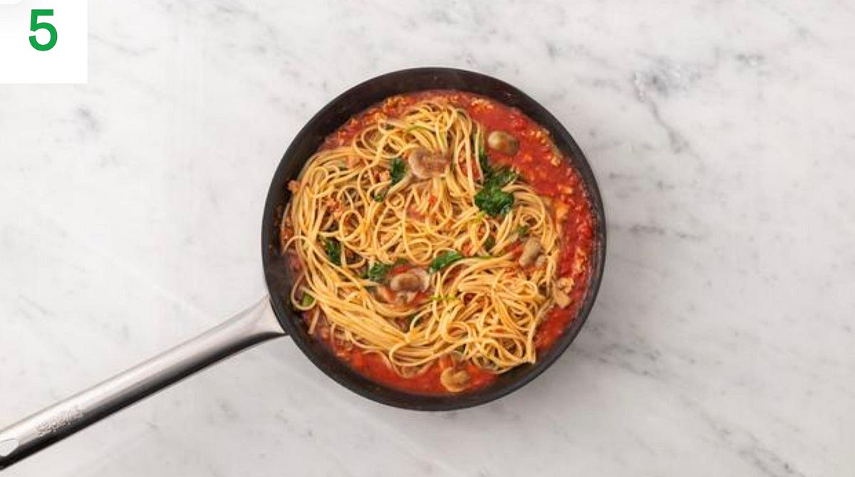 Once the sauce has thickened, add the spinach a handful at a time until wilted and piping hot, 1-2 mins.
Add a splash of water if it's a little too thick.
Stir in the pesto. Add the cooked pasta to the sauce along with three quarters of the cheese and stir to combine.
Add a splash of water if it's a little too thick. Taste and add salt and pepper if needed.