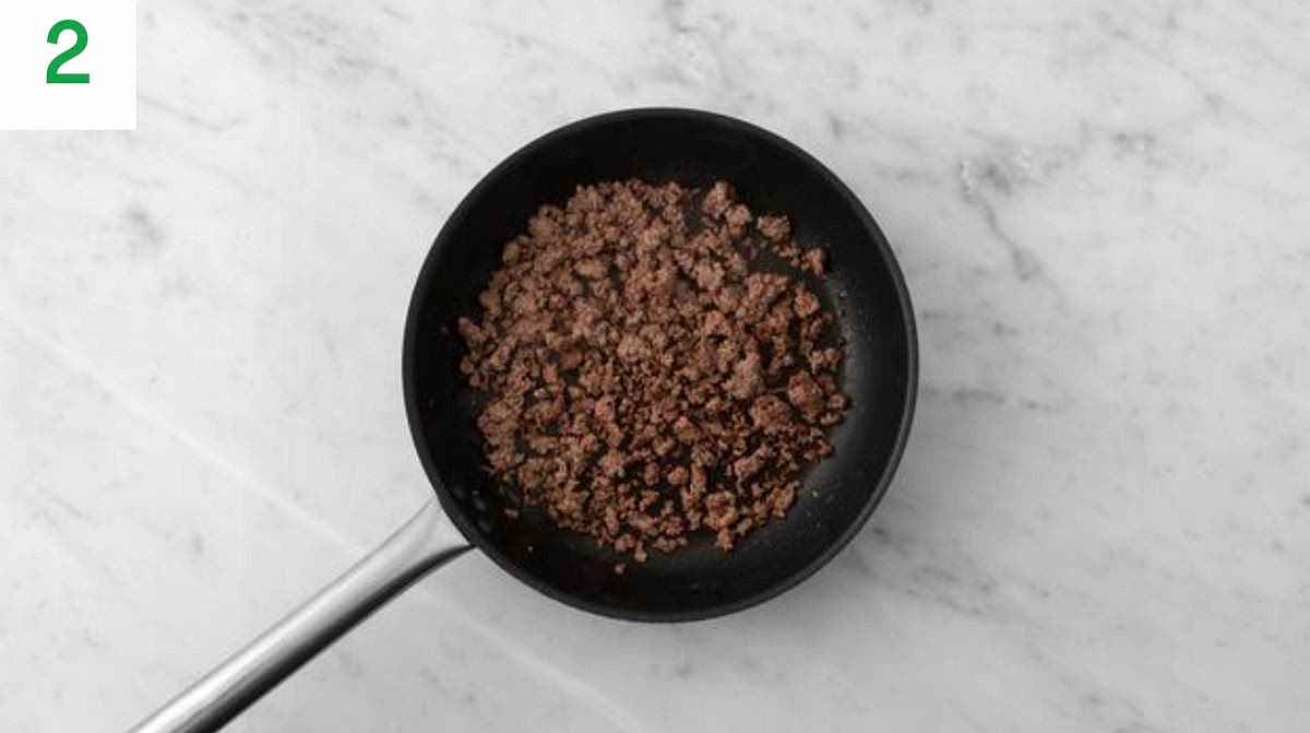 Meanwhile, heat a large frying pan on medium high heat (no oil)
Once hot, add the lamb mince and fry until browned, 5-6 mins. Use a spoon to break it up as it cooks.
IMPORTANT: Wash your hands and equipment a er handling raw mince. It' s cooked when no longer pink in
the middle.
While the mince browns, halve, peel and chop the onion into small pieces. Quarter the mushrooms.
Trim the carrot, then quarter lengthways (no need to peel). Chop widthways into small pieces.