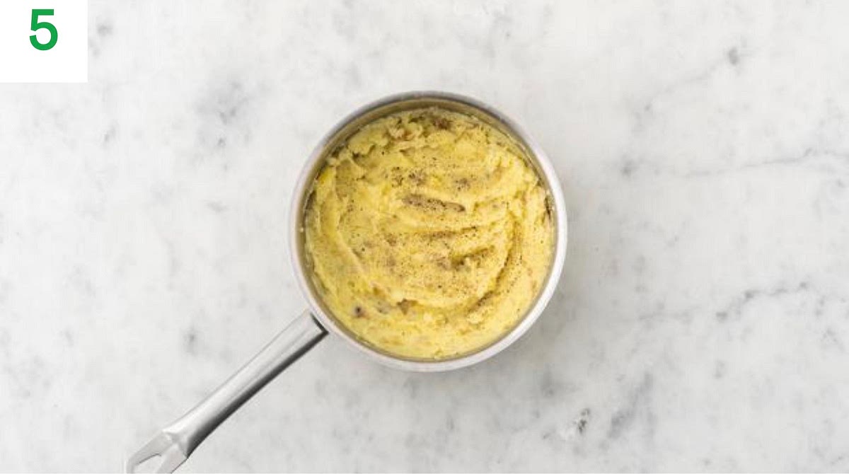 Meanwhile, strip the thyme leaves from their stalks and roughly chop (discard the stalks).
Once the potatoes are cooked, drain in a colander and return to the pan, oﬀ the heat. Add a knob of butter and a splash of milk (if you have any) and mash until smooth.
Season with salt and pepper, then cover with a lid tokeep warm.
Once the stew has thickened, stir through half the thyme.