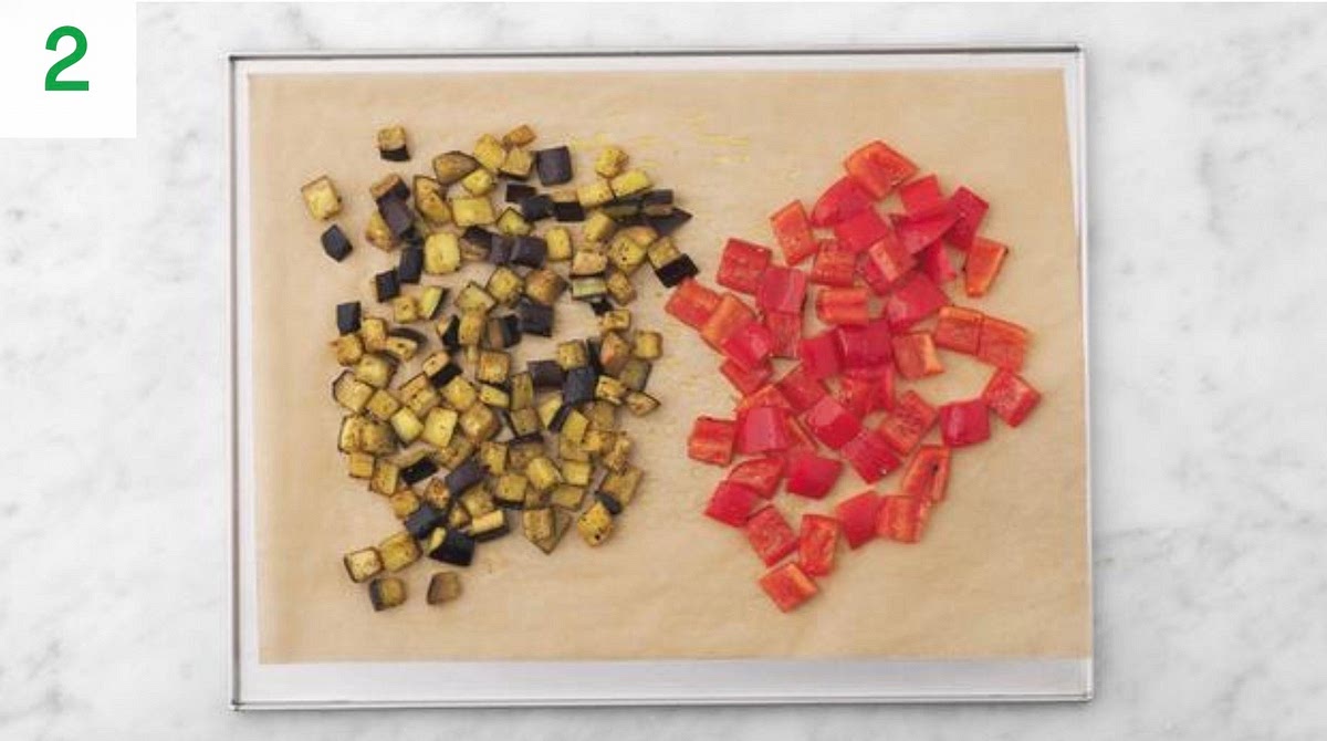 Pop the aubergine onto a large baking tray. Drizzle with oil, sprinkle over the dried oregano, season with salt and pepper, then toss to coat. Spread out in a single layer.
When the oven is hot, roast the aubergine on the top shelf until so  and golden, 25-30 mins.
When the aubergine is halfway through cooking, remove the tray from the oven and add the pepper to the tray. Drizzle with a little more oil, season with salt and pepper, then toss to coat together.
Return the tray to the top shelf for the remaining time until so  and slightly charred, 14-16 mins.