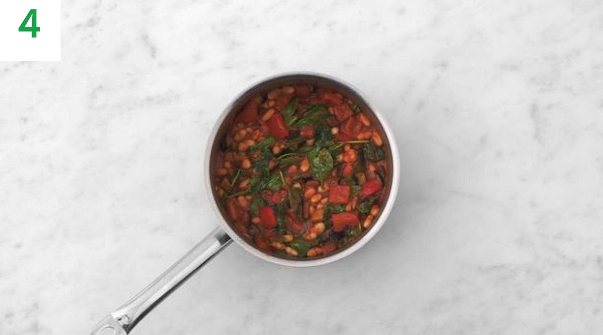 When the veg has finished roasting, pop the stew back on medium heat.
Stir the spinach into the stew a handful at a time until wilted and piping hot, 1-2 mins, along with the roasted veg and butter (see pantry for amount).
Taste and season with salt and pepper if needed. Add a splash of water if it's a little too thick.