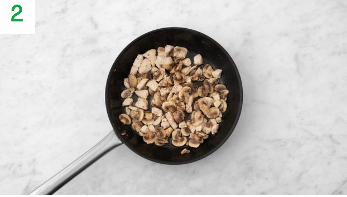 Meanwhile, heat a drizzle of oil in a large frying pan on medium-high heat.
Once hot, add the diced chicken and sliced mushrooms to the pan. Season with salt and pepper.
Wash your hands and equipment a er handling raw chicken and its packaging.
Cook until browned all over, 5-6 mins. Stir occasionally.