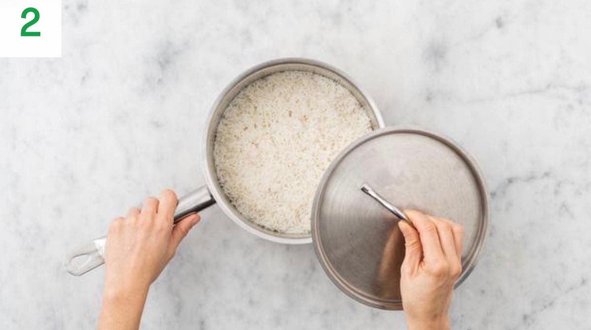 Meanwhile, boil a half-full kettle.
Pour the boiled water into a large saucepan with ¼ tsp salt on high heat. Add the rice and cook for 10-12 mins.
Once cooked, drain in a sieve and pop back in the pan.
Cover with a lid and leave to the side to steam for later.
