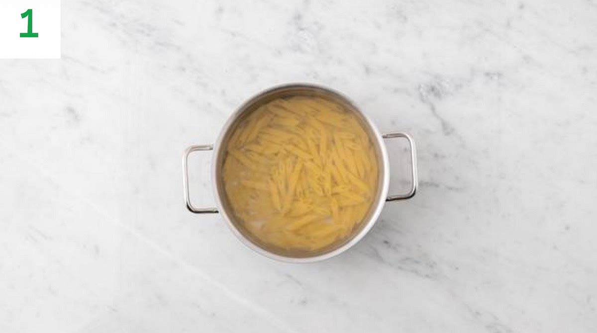 Boil a full kettle for the penne.
Pour the boiled water into a large saucepan with ½ tsp salt on high heat.
Add the penne and bring back to the boil. Cook until tender, 12 mins.
Once cooked, drain in a colander and pop back in the pan. Drizzle with oil and stir through to stop it sticking together.