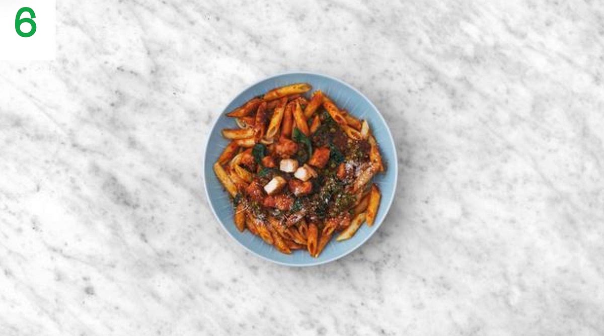 Share the chipotle chicken pasta between your serving bowls.
Sprinkle over the remaining cheese.