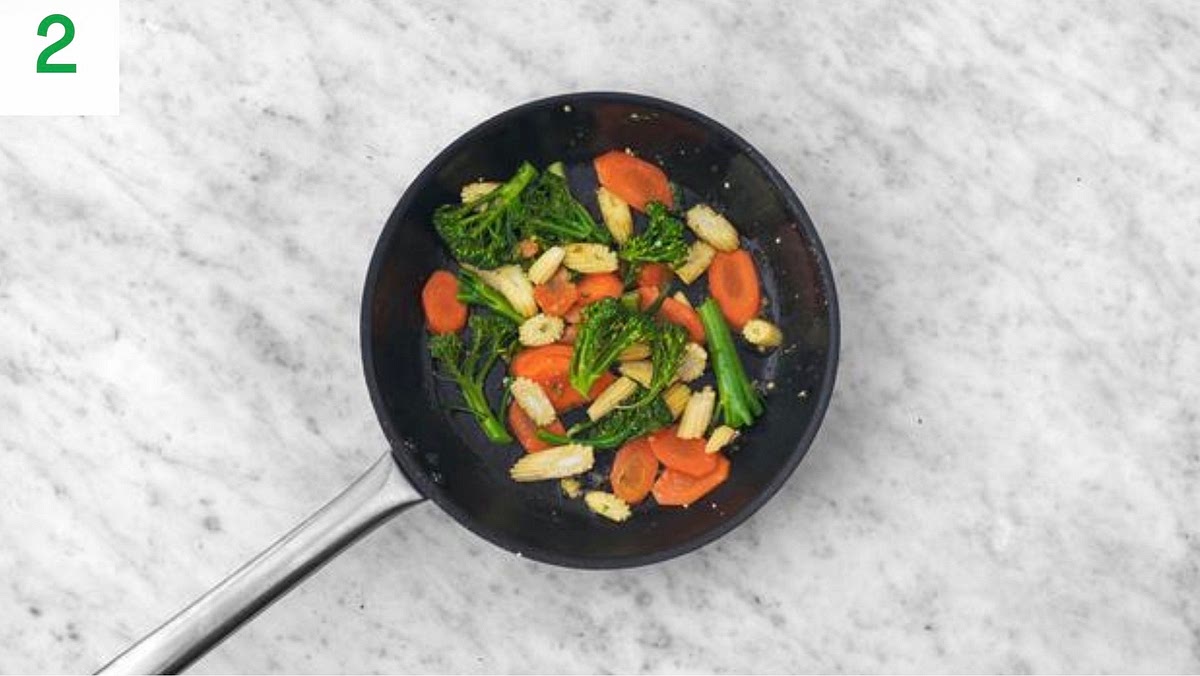 Heat a drizzle of oil in a large frying pan on high heat.
Add the broccoli, baby corn and carrot and stir-fry
until starting to soften, 5-6 mins.
Meanwhile, pour the boiled water into a medium saucepan with ½ tsp salt and bring to the boil.
Add the noodles and cook until tender, 4 mins. Once cooked, drain in a sieve and run under cold water to stop them sticking together.