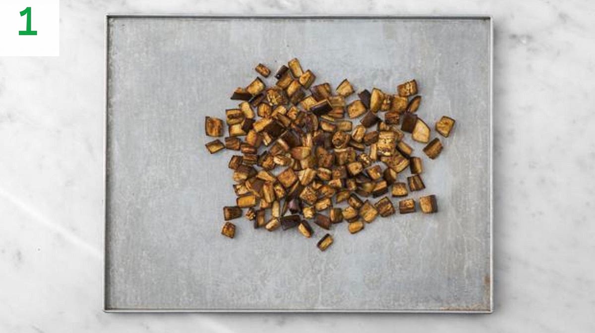 Preheat your oven to 240°C/220°C fan/gas mark 9.
Trim the aubergine, cut into 2cm pieces, then pop onto a large baking tray.
Drizzle with oil, sprinkle over the chermoula spice mix (add less if you'd prefer things milder), season with salt and pepper, then toss to coat. Spread out in a single layer.