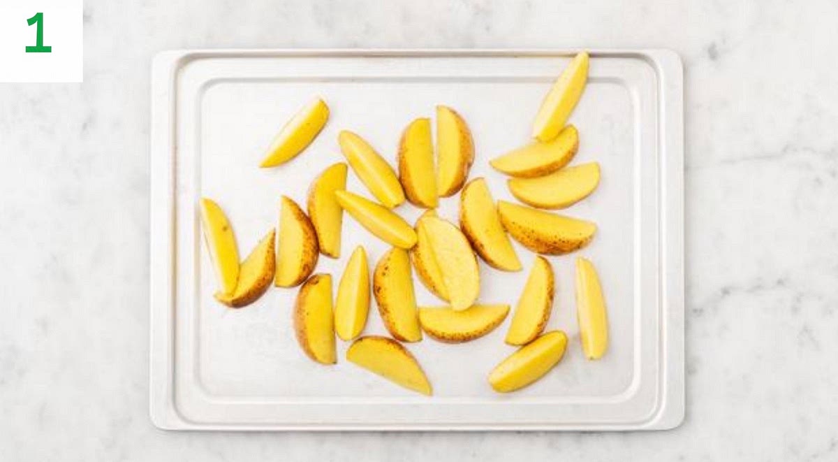 Preheat youroven to 220°C/200°C fan/gas mark 7.
Chopthepotatoes into 2cmwidewedges (no need to peel). Pop thewedges onto a large bakingtray. Drizzle with oil, seasonwith saltandpepper, then toss to coat.
Spread out in a single layer. TIP: Use two baking trays if necessary.
When theoven is hot, roast onthetopshelf until golden, 25-35 mins.