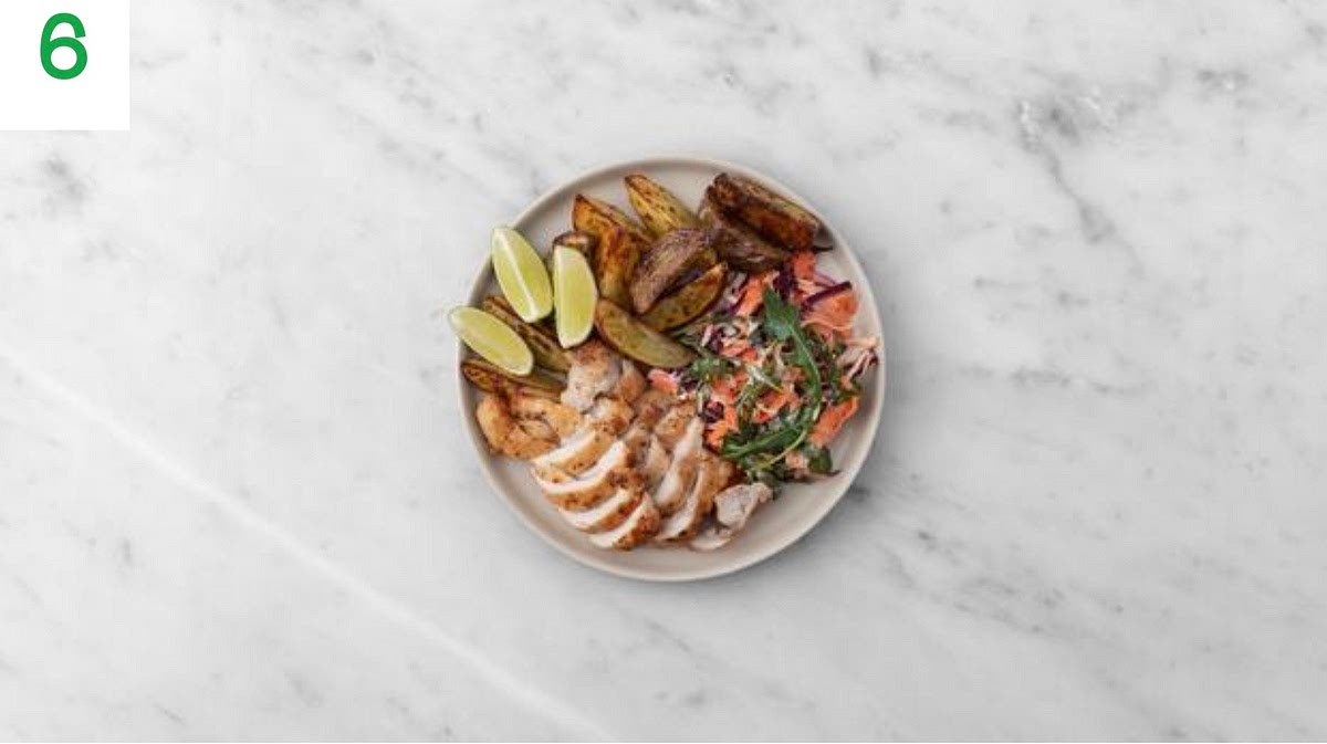 Share the Caribbean style jerk chicken thighs between your plates. Spoon over any remaining glaze from the tray.
Serve the honey lime wedges, tangy slaw and any remaining lime wedges alongside.