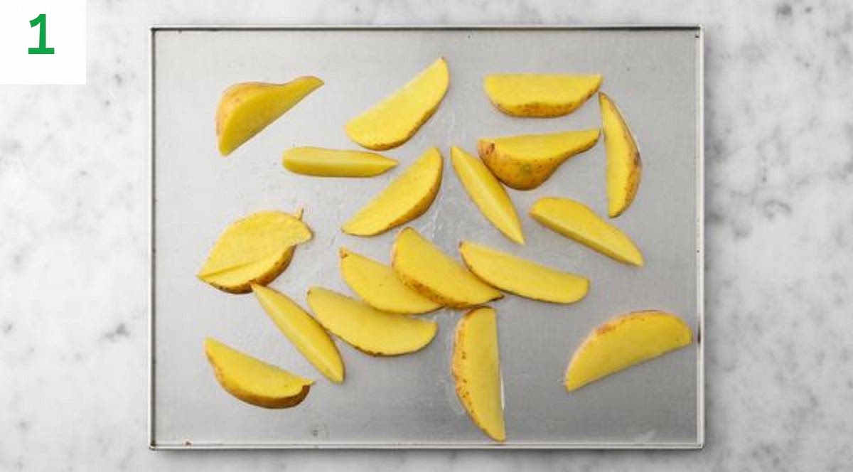 Preheat your oven to 220°C/200°C fan/gas mark 7.
Chop the potatoes into 2cm wide wedges. Pop onto a large baking tray. Drizzle with oil, season with salt and pepper, then toss to coat.
Spread out in a single layer. TIP: Use two baking trays if necessary.
When the oven is hot, roast on the middle shelf until golden, 30-40 mins. Turn halfway through.