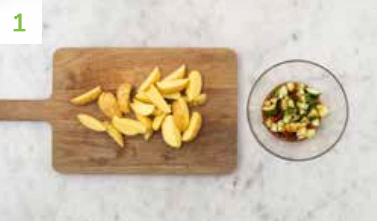 Preheat oven to 200°C. Chop the potatoes into 2cm wide wedges (no need to peel). Peel and grate the garlic (or use a garlic press). Put the soy sauce, rice vinegar, half the honey and half the sambal into a medium bowl. Mix together.
TIP: If your honey has hardened, pop it in a bowl of hot water for 1 min. Trim the cucumber, then pop onto a board and use a rolling pin to smack it a few times until split. Chop into roughly 2cm chunks. Add the cucumber to the bowl of marinade, toss to coat then set aside.