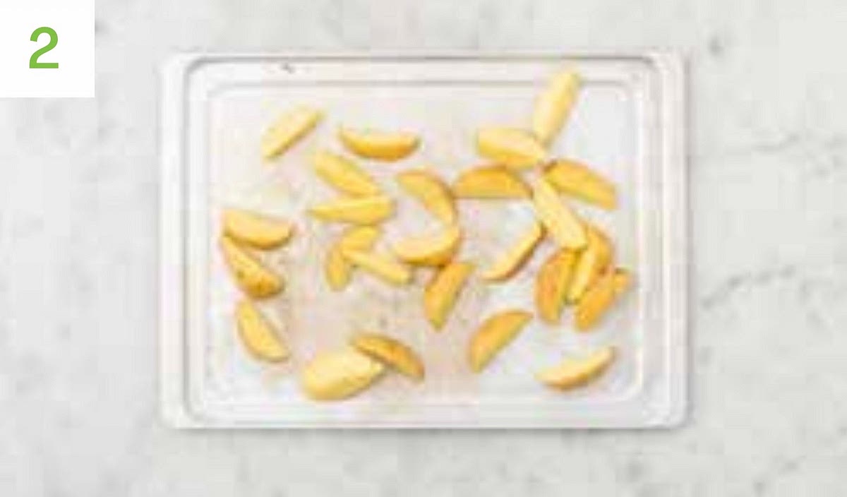 Pop the wedges onto a large baking tray. Drizzle with oil, sprinkle over the sesame seeds and season with salt and pepper. Toss to coat, then spread out in a single layer.
TIP: Use tow baking trays if necessary.
When the oven is hot, roast on the top shelf until golden, 25-35 mins. Turn halfway through. Meanwhile, pop the remaining sambal into a small bowl with the mayo. Mix together.