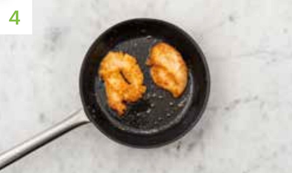 Put a large frying pan on high heat and add enough oil to completely coated the bottom of the pan.
TIP: you want the oil to be hot so the chicken fries properly - heat for 2-3 mins before you add the chicken.
Once hot, carefully lay the chicken into the pan and fry until golden-brown and cooked through, 10-12 mins total. Turn every 2-3 mins and adjust the heat as necessary. Once cooked, transfer the chicken breasts to a clean plate lined with kitchen paper.