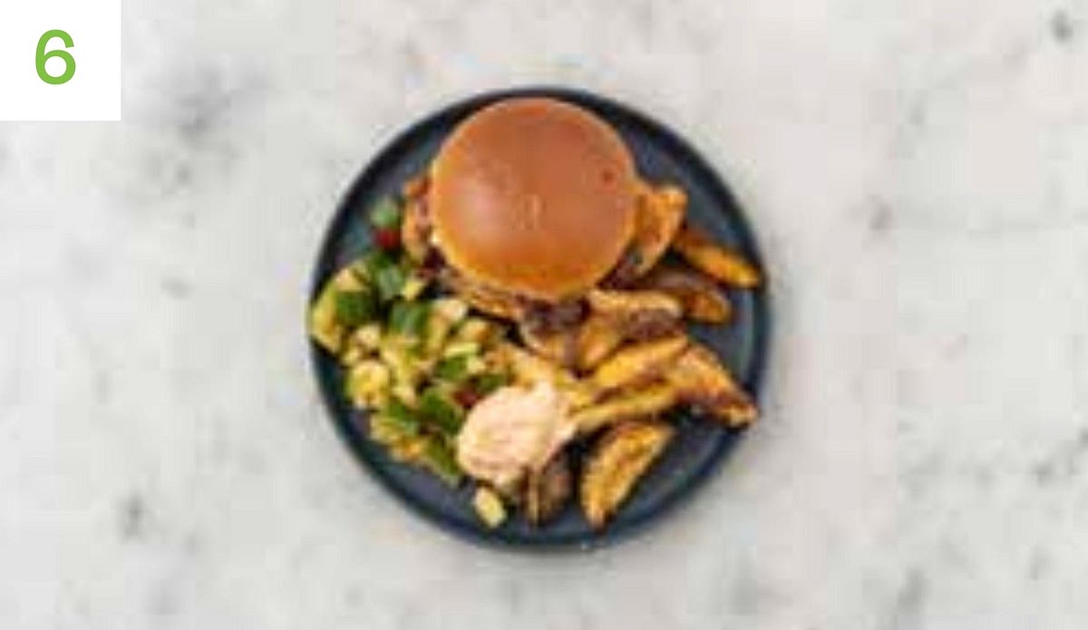 When almost ready to serve, halve the burger buns and pop into the oven to warm for 2-3 mins. Spread a spoonful of mayo onto each warmed bun base and top with the chicken and bacon. Spoon over some melted honey garlic butter on the cut side of the bun tops before sandwiching shut. Share the wedges, and serve the cucumber in a bowl alongside.