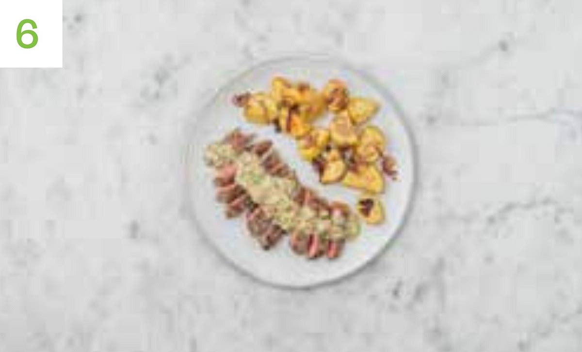 When ready, remove the potatoes from the oven and stir through the caramelised red onion. Keep warm in the oven while the steaks rest.
Reheat the peppercorn sauce on medium heat until piping hot. Stir through the parsley, then taste and season if needed.
Thinly slice each steak widthways, then serve with the Lyonnaise potatoes alongside. Spoon over the peppercorn sauce to finish.