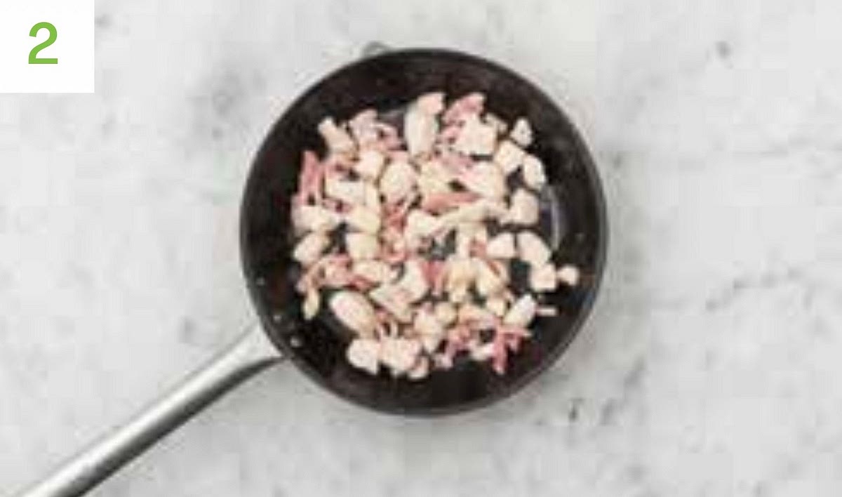Meanwhile, heat a drizzle of oil in a large frying pan on medium-high heat.
Once hot, add the chicken and season with salt and pepper. Stir fry until browned all over, 5-6 mins.
Add the bacon lardons and stir-fry until golden, 4-5 mins.