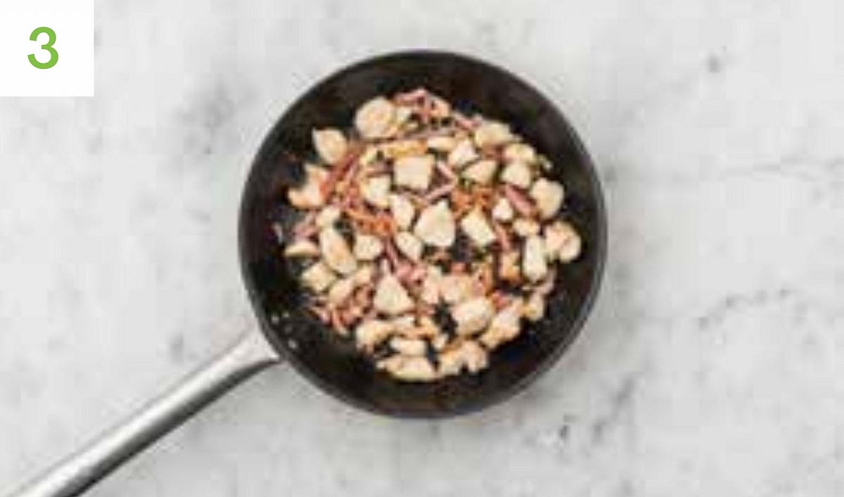 Add the garlic to the pan and stir-fry until fragrant, 30 secs.
Pour in the creme fraiche, chicken stock paste and water for the sauce (see pantry for amount),stirring to combine.