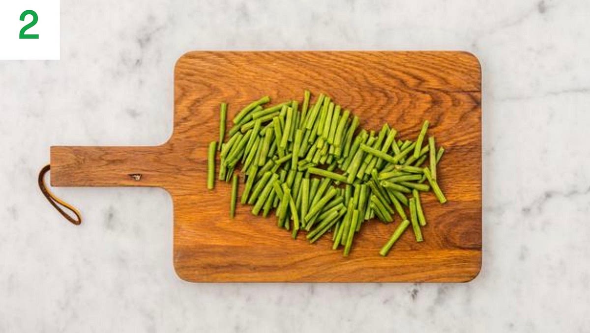 Meanwhile, trim the green beans.
Pop your beans onto a piece of foil with a drizzle of oil and season with salt and pepper. Toss to coat. Fold the foil, sealing on all sides to create a parcel.